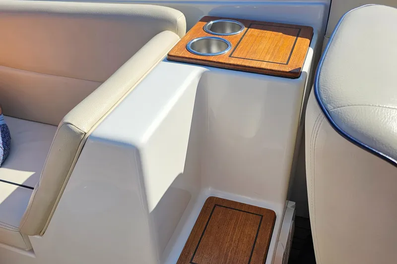 Slide: The Image of 2006 Chris-Craft Corsair 28 interior with cup holders and beige seating. - 55
