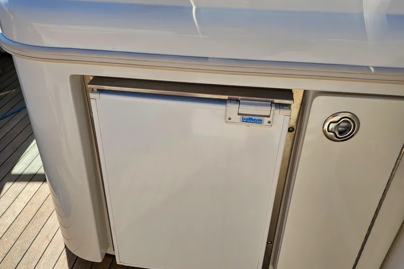 Slide: The Image of 2006 Chris-Craft Corsair 28 boat refrigerator on deck. - 56