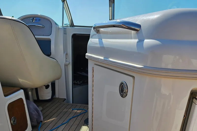 Slide: The Image of 2006 Chris-Craft Corsair 28 interior with seating and cabin door, showcasing luxury design. - 57