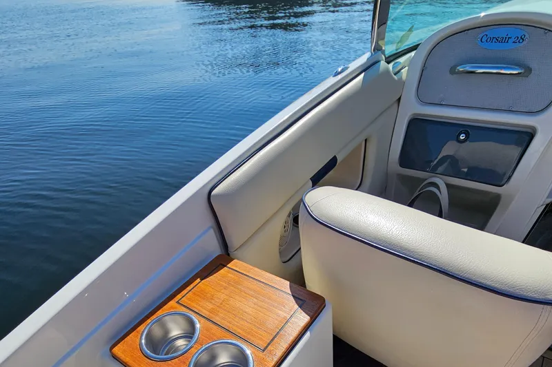 Slide: The Image of 2006 Chris-Craft Corsair 28 boat interior with cup holders and water view. - 59