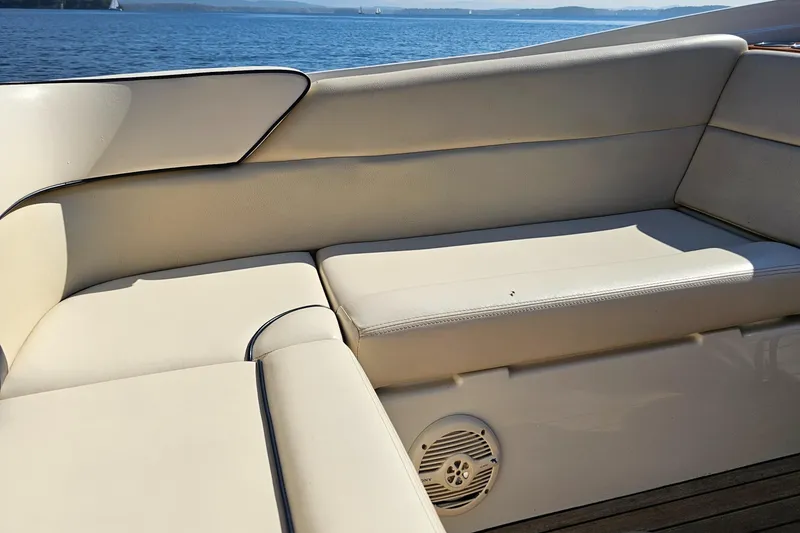 Slide: The Image of 2006 Chris-Craft Corsair 28 boat interior with beige seating and ocean view. - 60