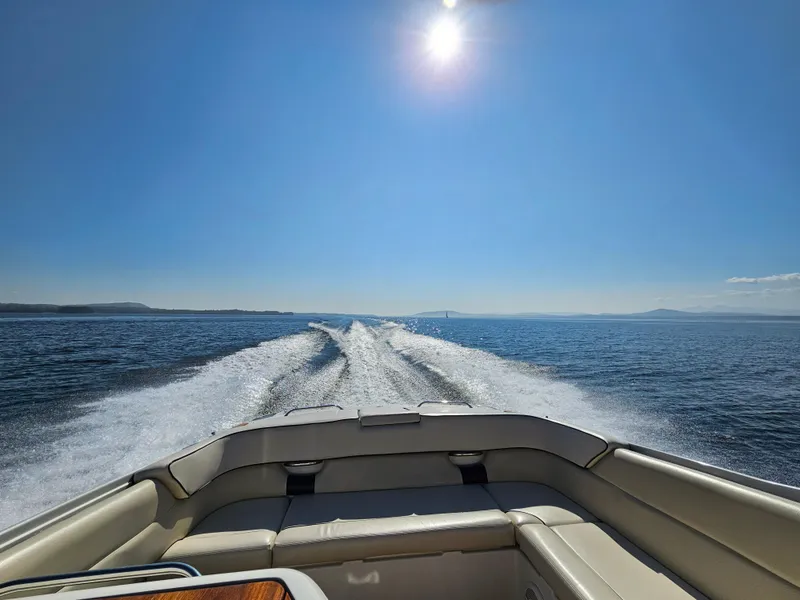 Slide: The Image of 2006 Chris-Craft Corsair 28 cruising on open water under a clear blue sky. - 64