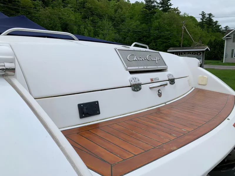 Slide: The Image of 2005 Chris-Craft Corsair 28 boat with teak swim platform, docked outdoors. - 7