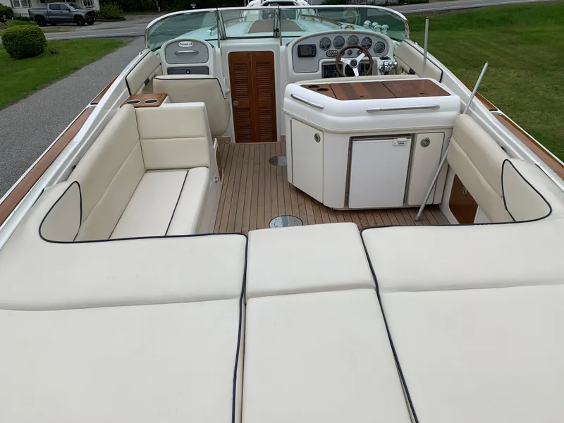 Slide: The Image of 2005 Chris-Craft Corsair 28 boat interior with cream seating and wooden accents. - 8