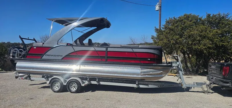 The Image of 2023 Berkshire 25RFX STS 3.0 pontoon boat on trailer, sunny day. - 1