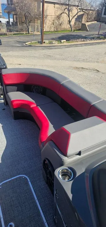 Slide: The Image of 2023 Berkshire 25RFX STS 3.0 boat interior with red and gray seating. - 13