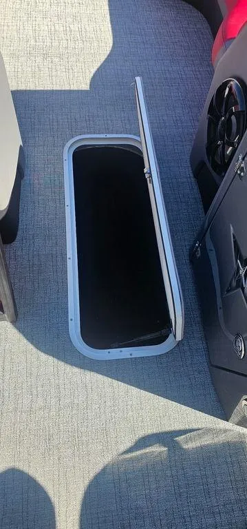 Slide: The Image of Open storage compartment on 2023 Berkshire 25RFX STS 3.0 boat interior. - 15