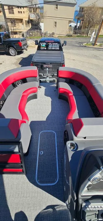 Slide: The Image of 2023 Berkshire 25RFX STS 3.0 pontoon boat with red and gray seating, parked on a trailer. - 21