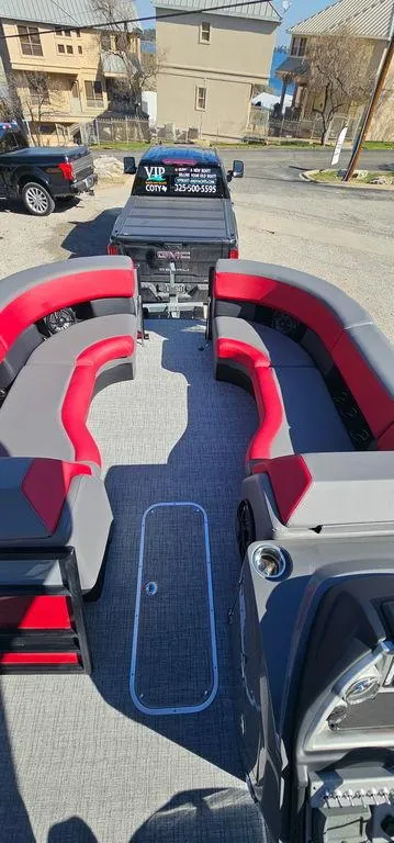 Slide: The Image of 2023 Berkshire 25RFX STS 3.0 pontoon boat with red and gray seating, parked on a trailer. - 22