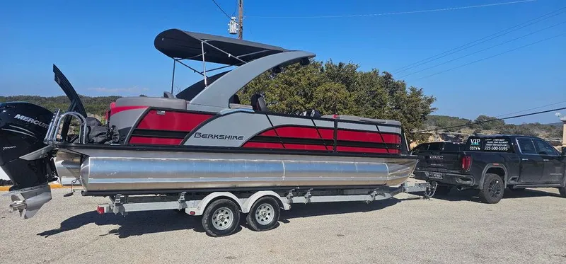 Slide: The Image of 2023 Berkshire 25RFX STS 3.0 pontoon boat on trailer, parked outdoors. - 3