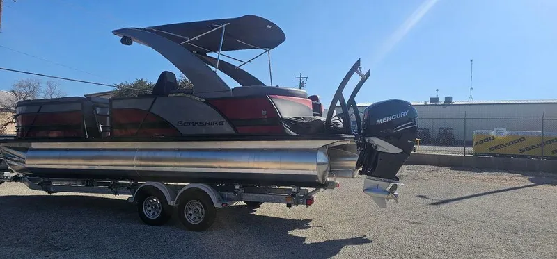 Slide: The Image of 2023 Berkshire 25RFX STS 3.0 pontoon boat on trailer, featuring Mercury outboard motor. - 5