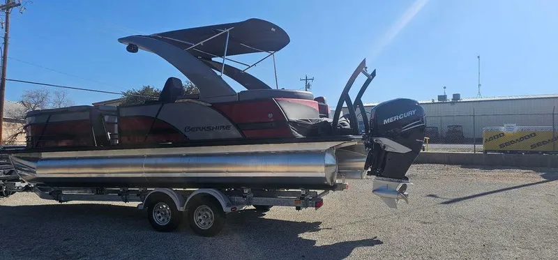 Slide: The Image of 2023 Berkshire 25RFX STS 3.0 pontoon boat on trailer, featuring Mercury outboard motor. - 6