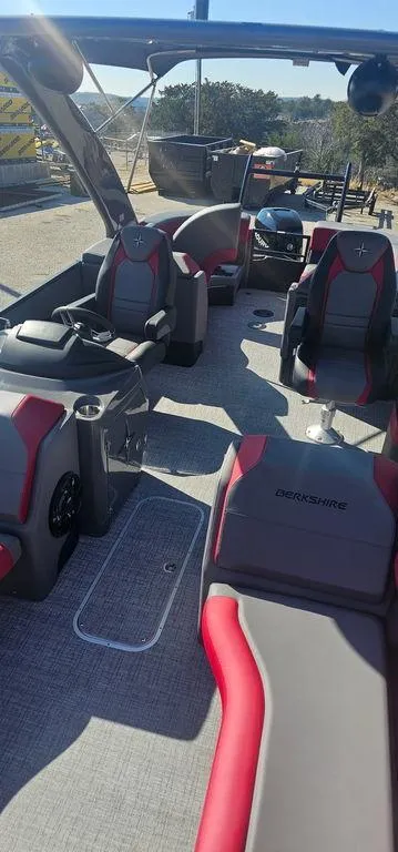 Slide: The Image of 2023 Berkshire 25RFX STS 3.0 pontoon boat interior with red and gray seating. - 7