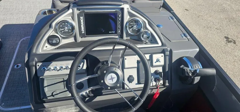 Slide: The Image of 2023 Berkshire 25RFX STS 3.0 boat dashboard with steering wheel and control panel. - 8