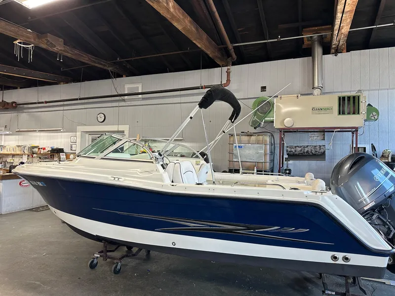 Slide: The Image of 2006 Hydra-Sports Lightning 202 DC boat in a workshop setting. - 0