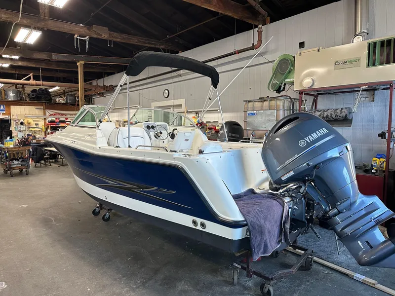 Slide: The Image of 2006 Hydra-Sports Lightning 202 DC boat with Yamaha engine in a workshop setting. - 1