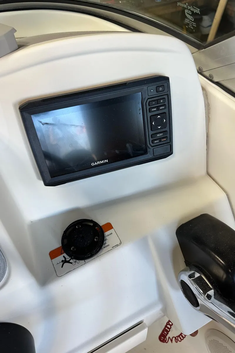 Slide: The Image of 2006 Hydra-Sports Lightning 202 DC dashboard with Garmin display and controls. - 13