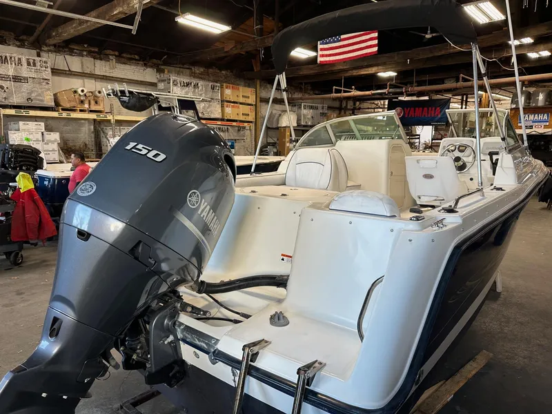 Slide: The Image of 2006 Hydra-Sports Lightning 202 DC boat with Yamaha 150 engine in a workshop setting. - 2