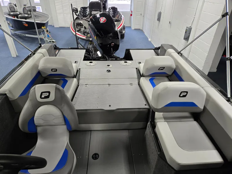 Slide: The Image of 2025 Princecraft Sport 188 boat interior with seating and motor, displayed in showroom. - 11