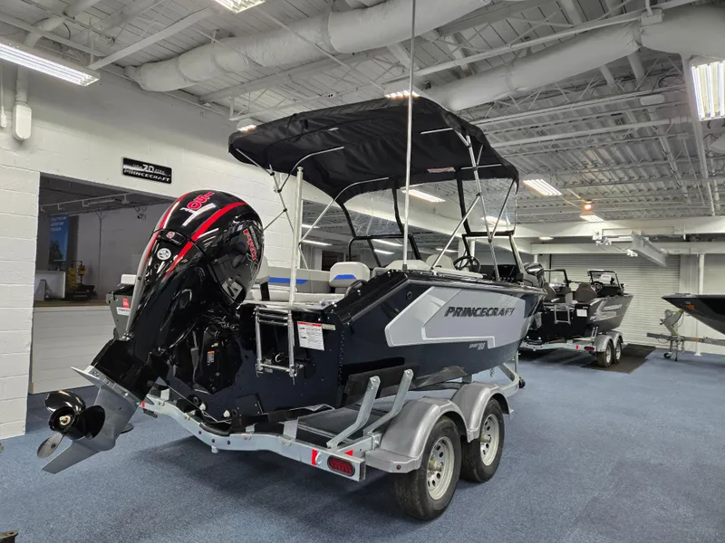 Slide: The Image of 2025 Princecraft Sport 188 boat on trailer in showroom, featuring a powerful outboard motor. - 3