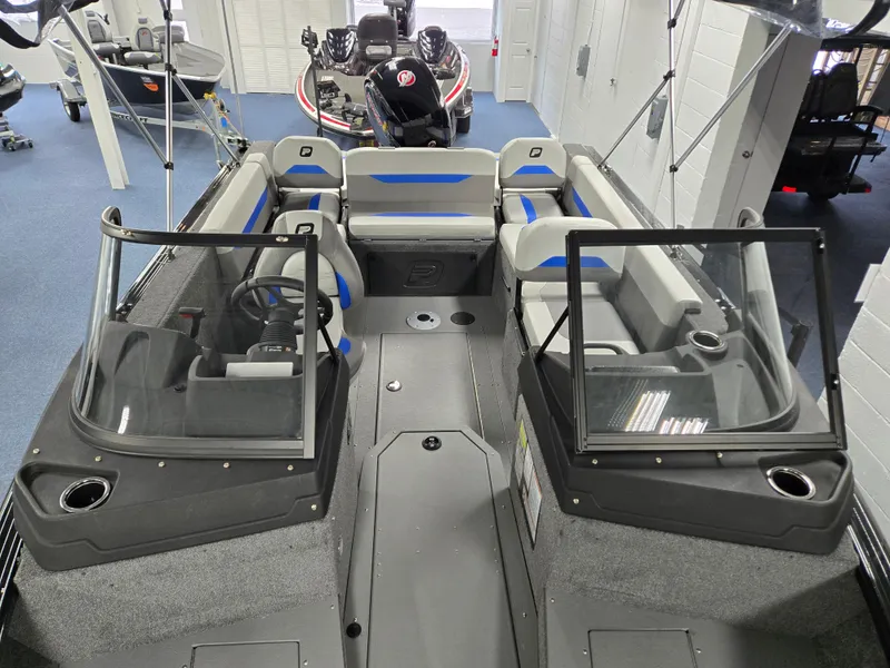 Slide: The Image of 2025 Princecraft Sport 188 boat interior with seating and windshield, displayed in showroom. - 8