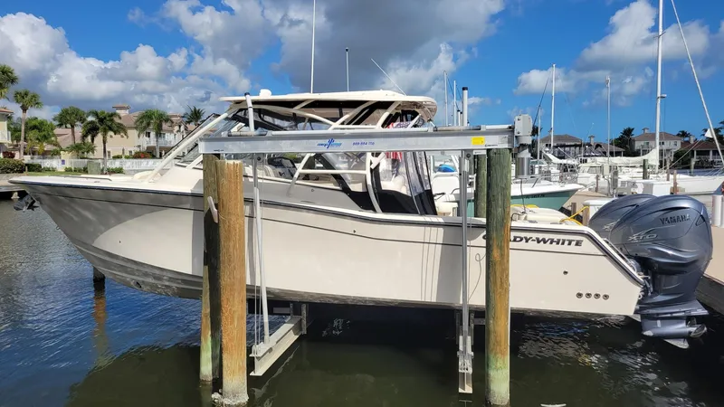The Image of 2021 Grady-White Freedom 335 boat docked at marina under blue sky. - 1