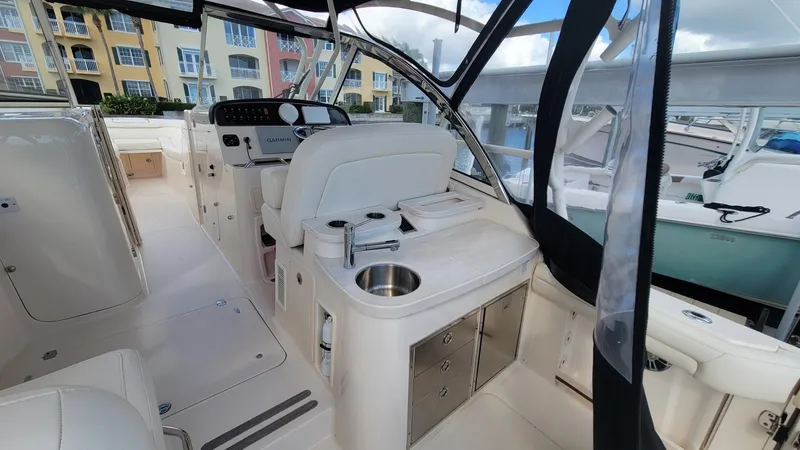 Slide: The Image of 2021 Grady-White Freedom 335 boat interior with helm, seating, and kitchenette. - 12
