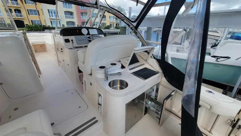 Slide: The Image of 2021 Grady-White Freedom 335 boat interior with helm, seating, and amenities. - 13