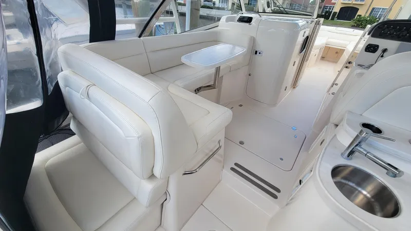 Slide: The Image of Interior of 2021 Grady-White Freedom 335 boat with white seating and modern amenities. - 14