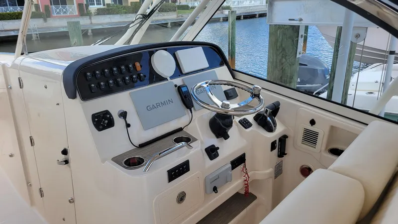 Slide: The Image of 2021 Grady-White Freedom 335 helm with Garmin navigation system, docked at marina. - 15