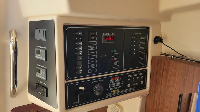 Slide: The Image of Control panel of 2021 Grady-White Freedom 335 boat, featuring various switches and displays. - 19