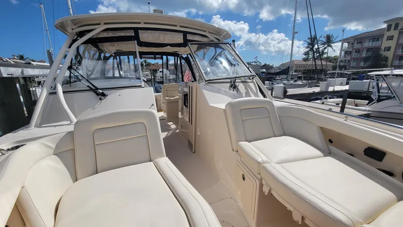 Slide: The Image of 2021 Grady-White Freedom 335 boat interior with plush seating at marina. - 26