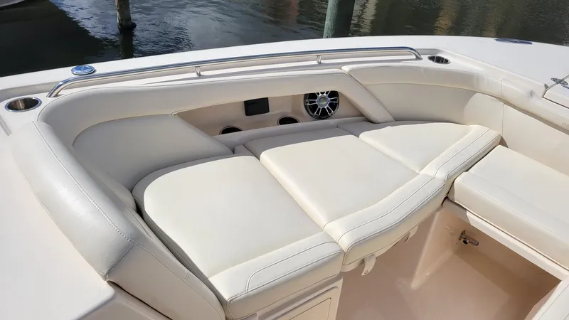 Slide: The Image of 2021 Grady-White Freedom 335 boat interior with cushioned seating and speaker system. - 28