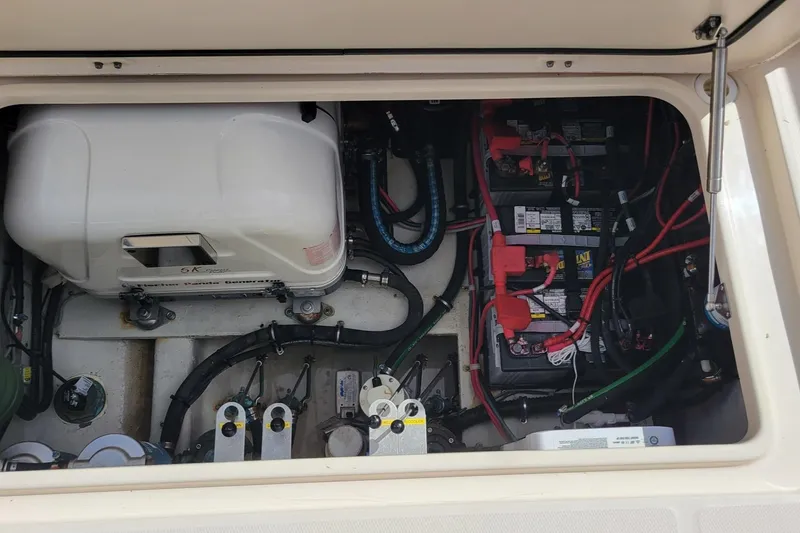 Slide: The Image of Engine compartment of 2021 Grady-White Freedom 335 boat, showing batteries and wiring. - 30