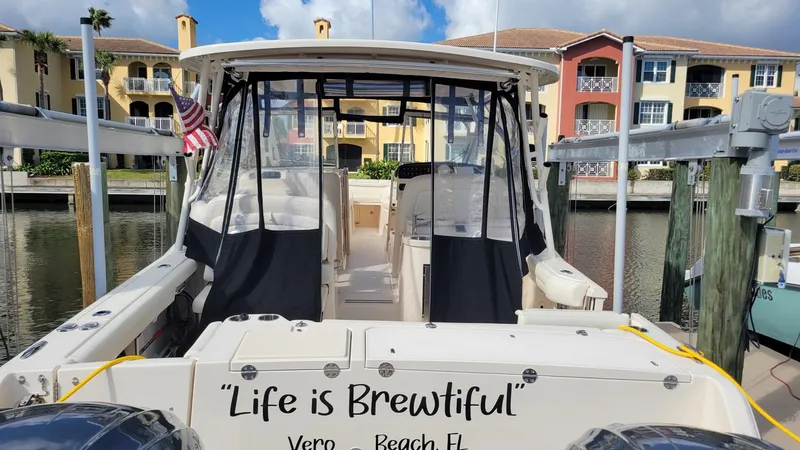 Slide: The Image of 2021 Grady-White Freedom 335 boat docked, "Life is Brewtiful" text, Vero Beach, FL. - 4
