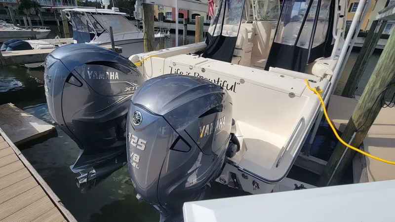 Slide: The Image of 2021 Grady-White Freedom 335 boat with twin Yamaha 425 engines docked at marina. - 5