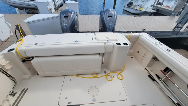 Slide: The Image of 2021 Grady-White Freedom 335 boat deck with dual engines at dock. - 8