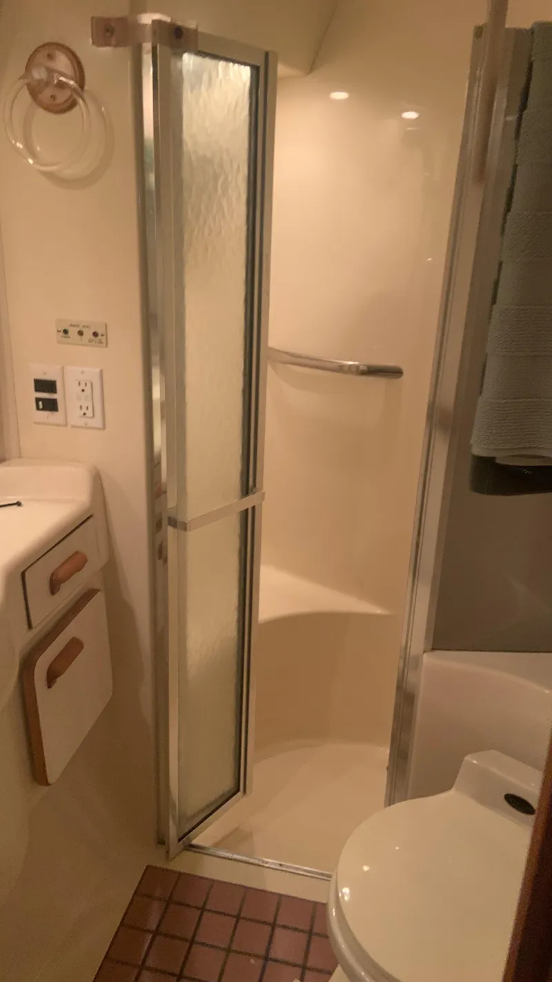 Slide: The Image of Bathroom interior of 1994 Sea Ray 500 Sundancer yacht, featuring shower and sink. - 16