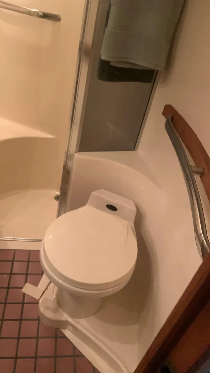 Slide: The Image of Bathroom interior of 1994 Sea Ray 500 Sundancer yacht, featuring toilet and shower area. - 17
