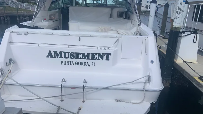 Slide: The Image of 1994 Sea Ray 500 Sundancer docked, named "Amusement," in Punta Gorda, FL. - 2