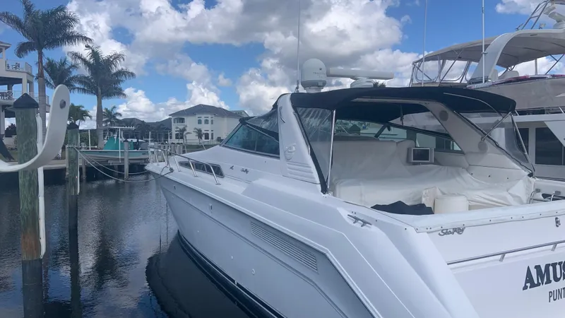 Slide: The Image of Sea Ray 500 Sundancer 1994 yacht docked at marina under cloudy sky. - 3
