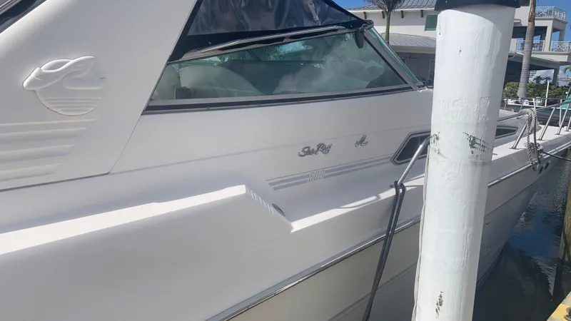 Slide: The Image of 1994 Sea Ray 500 Sundancer yacht docked at marina, side view. - 4