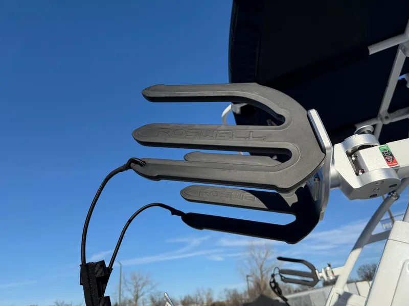 Slide: The Image of Wakeboard rack on 2025 Cobalt R6 Surf boat under clear blue sky. - 13