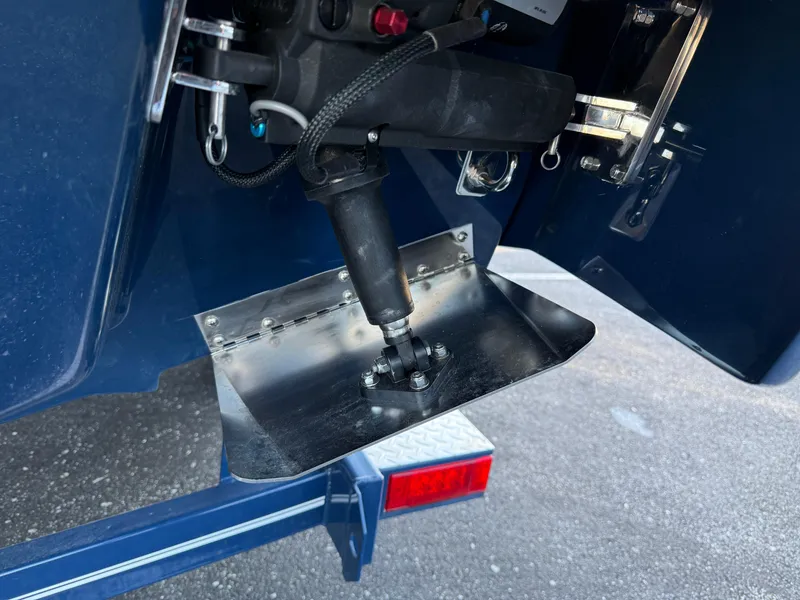 Slide: The Image of 2025 Cobalt R6 Surf boat's trim tab and hydraulic system close-up. - 17