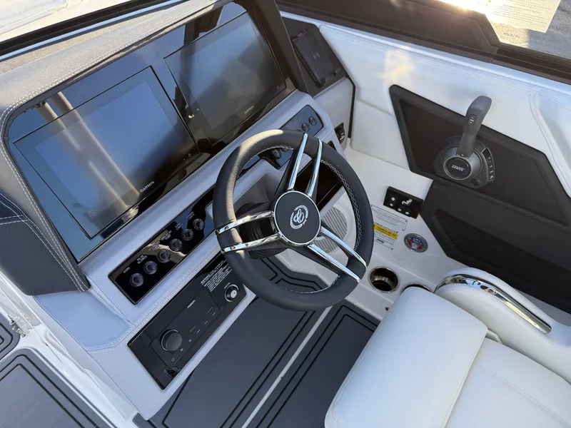 Slide: The Image of 2025 Cobalt R6 Surf boat cockpit with modern steering and control panel. - 19
