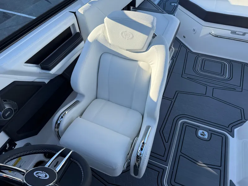 Slide: The Image of Luxurious white captain's chair in 2025 Cobalt R6 Surf boat interior. - 27