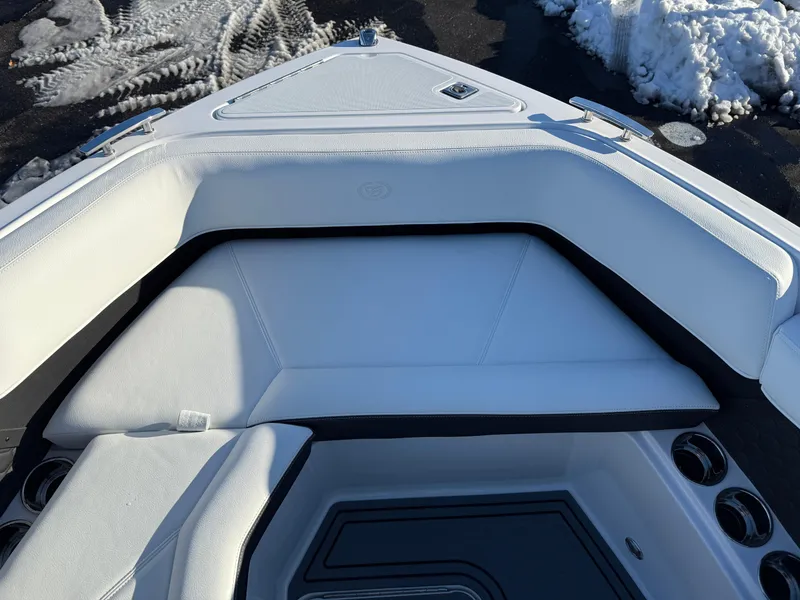 Slide: The Image of 2025 Cobalt R6 Surf boat interior with white seating and cup holders. - 32