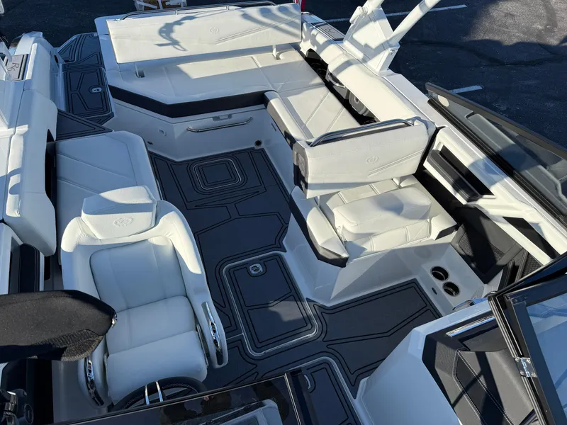 Slide: The Image of 2025 Cobalt R6 Surf boat interior with luxurious white seating and sleek design. - 33