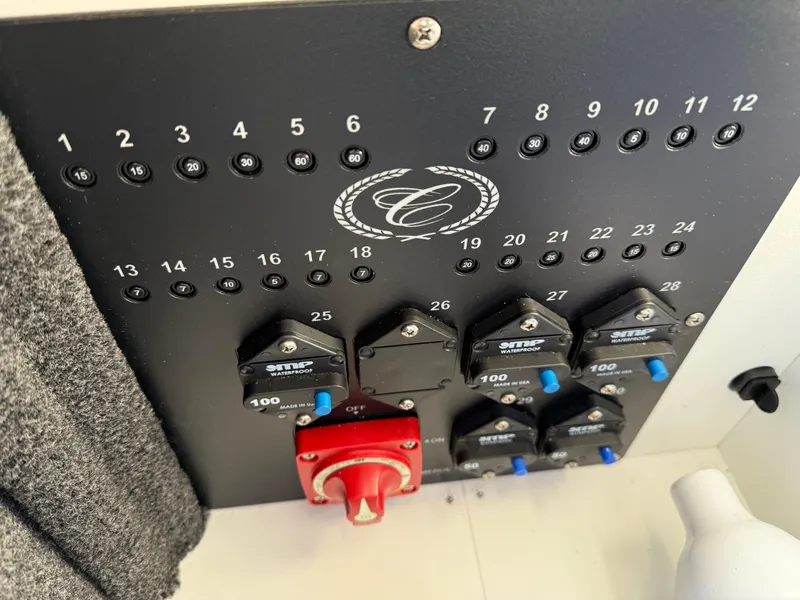 Slide: The Image of Control panel of 2025 Cobalt R6 Surf boat with switches and circuit breakers. - 39