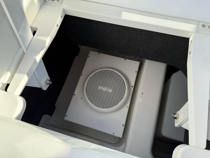 Slide: The Image of 2025 Cobalt R6 Surf boat storage compartment with integrated speaker system. - 41